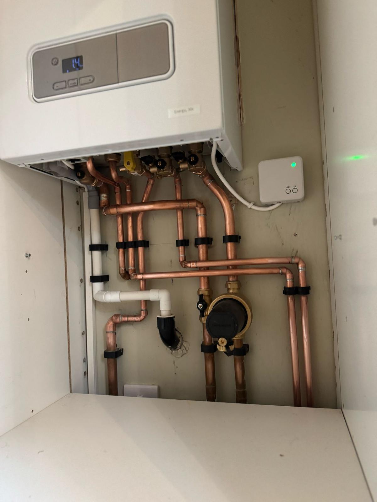 Boiler in an existing cupboard with copper pipework and isolation valves
