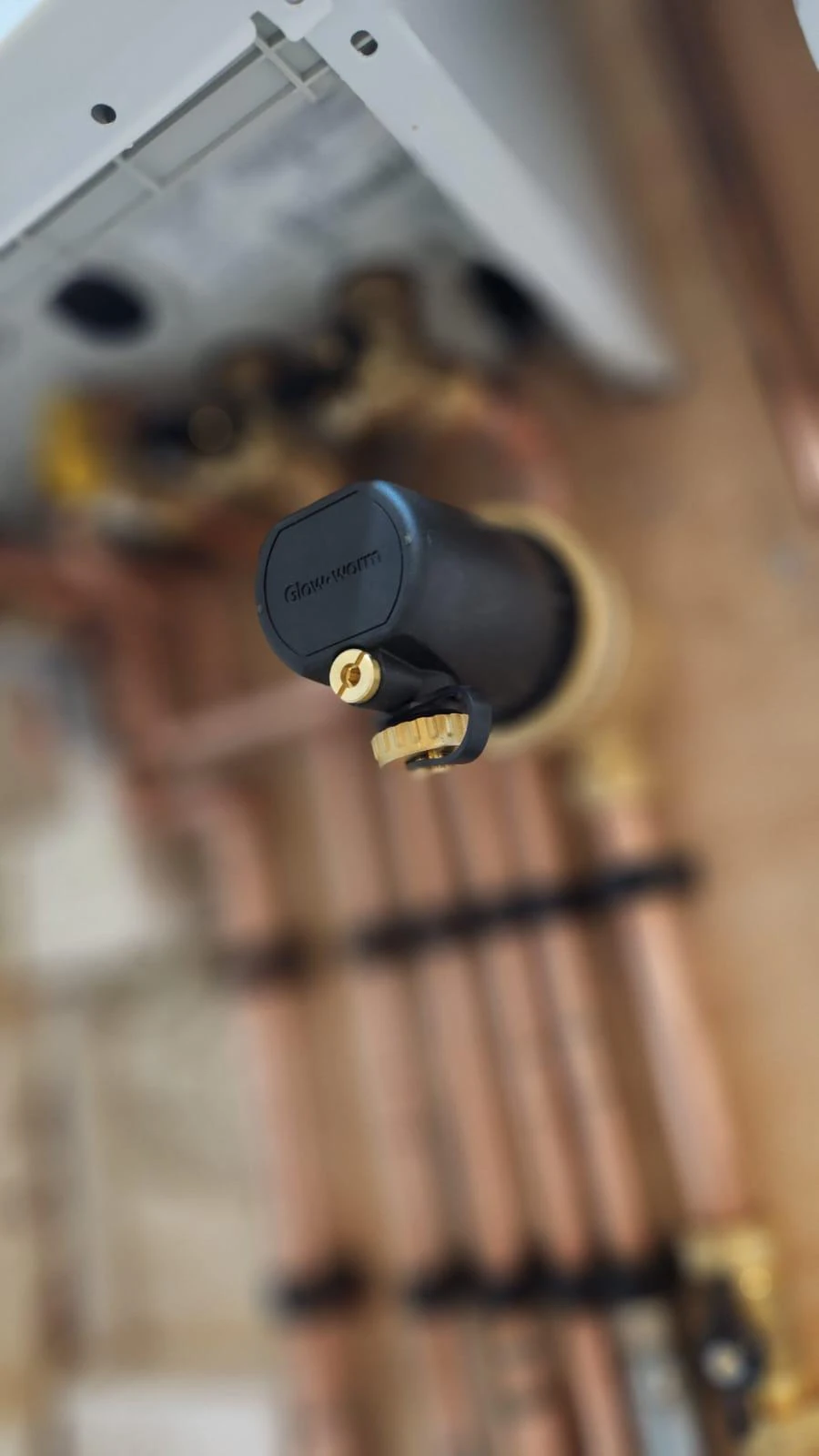 Glow-worm system filter and copper pipework above a boiler