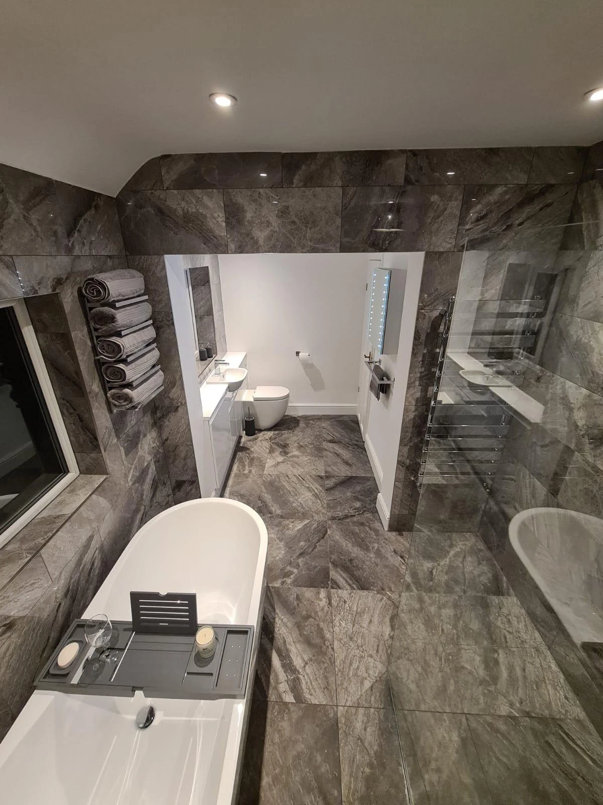 Reverse view of the Farnborough Park bathroom with bath and tiled finishes